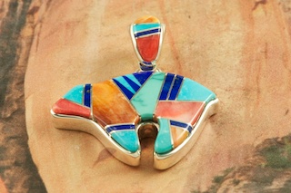 Genuine Turquoise, Spiny Oyster Shell and Blue Lapis inlaid between ribbons of Sterling Silver. Stunning Reversible Bear Pendant with Contemporary Sterling Silver Design. Free 18" Sterling Silver Chain with Purchase of Pendant. Designed by Navajo Artist Calvin Begay. Signed by the artist.